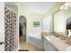 Bright main bathroom with a walk-in shower, garden tub, and dual sink vanity at 824 Casterton Cir, Davenport, FL 33897