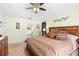 The main bedroom features a ceiling fan, soft yellow walls, and a full bathroom with a garden tub at 824 Casterton Cir, Davenport, FL 33897
