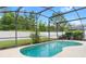 Sparkling in-ground pool surrounded by a screened enclosure at 824 Casterton Cir, Davenport, FL 33897