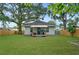 Beautiful backyard showcasing a home with light siding, a cozy porch, and a fenced yard at 832 Donnelly Pl, Daytona Beach, FL 32114