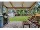 Outdoor deck with seating overlooks a spacious backyard with lush greenery and a storage shed at 832 Donnelly Pl, Daytona Beach, FL 32114