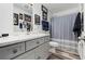 Bathroom with a light grey vanity, framed artwork, shower with curtain, and modern finishes at 832 Donnelly Pl, Daytona Beach, FL 32114