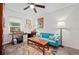 Cozy room with a blue sofa, workspace desk, colorful rug, and a Statue of Liberty painting at 832 Donnelly Pl, Daytona Beach, FL 32114