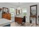 Charming dining area with a chandelier, bright windows, a wood table and decorative accents at 832 Donnelly Pl, Daytona Beach, FL 32114