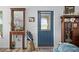 Bright entryway featuring a blue door, classic decor, and elegant furnishings at 832 Donnelly Pl, Daytona Beach, FL 32114