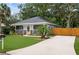 Charming home with a well-manicured lawn, inviting front porch, and a paver driveway at 832 Donnelly Pl, Daytona Beach, FL 32114