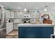 Well-lit kitchen with a large island, stainless steel appliances, bright counters and neutral cabinets at 832 Donnelly Pl, Daytona Beach, FL 32114