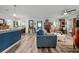 Sunlit living room featuring hardwood floors and a view into a modern kitchen at 832 Donnelly Pl, Daytona Beach, FL 32114