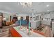 Open concept living space with updated flooring, a kitchen island, bright windows, and comfortable furniture at 832 Donnelly Pl, Daytona Beach, FL 32114