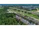 Aerial view of townhomes alongside a golf course, providing picturesque views and recreational opportunities at 893 Assembly Ct, Reunion, FL 34747
