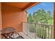 Private balcony with outdoor seating, offering serene views of lush greenery and blue skies at 893 Assembly Ct, Reunion, FL 34747