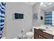 This bathroom offers a single sink vanity with a framed mirror and shower/tub combo at 893 Assembly Ct, Reunion, FL 34747