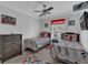 This bedroom features twin beds, a ceiling fan and television, ideal for children or guests at 893 Assembly Ct, Reunion, FL 34747