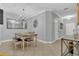 Spacious dining room featuring modern lighting, tile flooring, and neutral wall paint at 893 Assembly Ct, Reunion, FL 34747