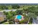 Aerial view of a community pool surrounded by lounge chairs and tropical foliage at 893 Assembly Ct, Reunion, FL 34747