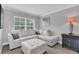 Cozy sitting room featuring a plush sectional sofa, neutral decor, and natural lighting at 893 Assembly Ct, Reunion, FL 34747