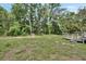 Backyard with lawn, fire pit, swing set, play house and a small deck at 910 Braddock Rd, Enterprise, FL 32725
