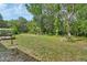 Backyard with lawn, fire pit, swing set, play house and a small deck at 910 Braddock Rd, Enterprise, FL 32725