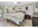 Bedroom with a gray bed frame, tiled floors, ceiling fan, and sun-drenched windows at 910 Braddock Rd, Enterprise, FL 32725