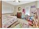 Cozy bedroom features playful decor, natural light, and ample storage at 910 Braddock Rd, Enterprise, FL 32725