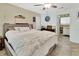 Bedroom with a gray bed frame, tiled floors, ceiling fan, and en suite bath at 910 Braddock Rd, Enterprise, FL 32725