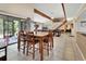 Dining area adjacent to living area features wooden table and access to back porch at 910 Braddock Rd, Enterprise, FL 32725
