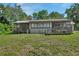 House exterior with lawn and a screened patio at 910 Braddock Rd, Enterprise, FL 32725