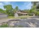 Two-story home with a long driveway, garage and car port at 910 Braddock Rd, Enterprise, FL 32725