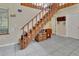 Open foyer features beautiful staircase with wooden steps and access to upper level at 910 Braddock Rd, Enterprise, FL 32725