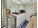 This updated kitchen features stainless steel appliances, white cabinetry, and butcher block countertops at 910 Braddock Rd, Enterprise, FL 32725
