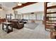 Spacious living room with a vaulted ceiling, comfortable leather seating, and large windows at 910 Braddock Rd, Enterprise, FL 32725