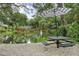 Backyard features a tranquil water feature with picnic tables in a well-maintained landscape at 940 Douglas Ave # 189, Altamonte Springs, FL 32714