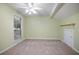 Bedroom features a ceiling fan, window, carpet, and light green walls at 940 Douglas Ave # 189, Altamonte Springs, FL 32714