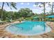 Large community pool with comfortable lounge chairs and a beautiful tree lined back drop for residents at 940 Douglas Ave # 189, Altamonte Springs, FL 32714