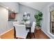 Bright dining area featuring wood floors, modern decor, and views into the kitchen at 940 Douglas Ave # 189, Altamonte Springs, FL 32714