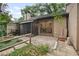 Back exterior view showcasing the patio, fence, mature trees, and landscaping at 940 Douglas Ave # 189, Altamonte Springs, FL 32714