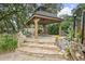 Stone steps lead to a hot tub gazebo and outdoor seating area at 940 Douglas Ave # 189, Altamonte Springs, FL 32714