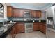 Modern kitchen featuring stainless steel appliances, granite counters, and wood cabinets at 940 Douglas Ave # 189, Altamonte Springs, FL 32714