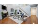 Bright living room with high ceilings, wood floors, a fireplace, and staircase at 940 Douglas Ave # 189, Altamonte Springs, FL 32714