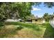 The backyard has a home with a screened porch, a large tree, and a white fence at 952 N Fairbairn Dr, Deltona, FL 32725