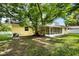 The private backyard boasts a screened patio, mature tree, and outdoor air conditioning condenser at 952 N Fairbairn Dr, Deltona, FL 32725