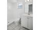 Bright bathroom featuring a walk-in shower, marble floors, vanity, and a toilet at 952 N Fairbairn Dr, Deltona, FL 32725