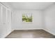 Bright bedroom featuring wood-look flooring, white walls, large window and closet at 952 N Fairbairn Dr, Deltona, FL 32725