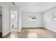Open bedroom with wood-look floors, a closet, and an adjacent bathroom at 952 N Fairbairn Dr, Deltona, FL 32725
