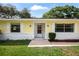 Inviting front entrance with white trim, a storm door, and lush green landscaping at 952 N Fairbairn Dr, Deltona, FL 32725