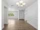 Inviting entryway with modern light fixture and sleek, continuous wood flooring at 952 N Fairbairn Dr, Deltona, FL 32725