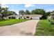 Charming single-story home with yellow paint, attached garage, and a long driveway at 952 N Fairbairn Dr, Deltona, FL 32725