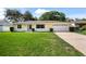 Close-up of charming yellow home featuring an attached garage and vibrant green lawn at 952 N Fairbairn Dr, Deltona, FL 32725