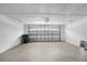 Spacious two-car garage with white walls and a sealed concrete floor. The garage door is paneled steel at 952 N Fairbairn Dr, Deltona, FL 32725
