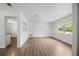 Spacious living room featuring wood floors, white walls, and a bright, sunny window at 952 N Fairbairn Dr, Deltona, FL 32725